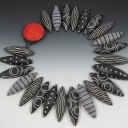 Hey, all, I just started a folder of the work I will do in 2013 - great way to have some record (which I currently don't, everything is mushed up together!).  Take a look, here is the latest necklace I made, a series of black and cream pods with a bright red clasp!